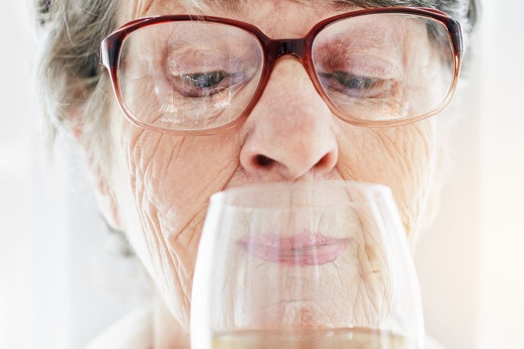 70 years old woman with a wine glass