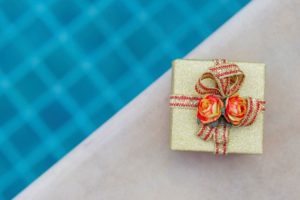 wrapped present at the border of a swimming pool